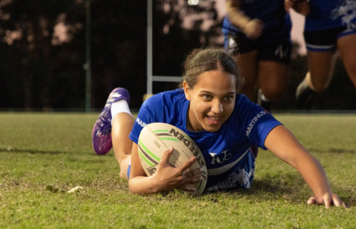 Gilr smiling playing football